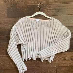 Cute crop sweater with hem details.